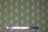 Flat swatch Lilliput fabric (pale green fabric with spaced smiling frog heads and tossed dark green doodles allover: floral, bugs, leaves, etc.)