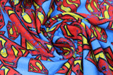 Swirled swatch distressed superman logo fabric (bright blue fabric with tossed superman logos in various sizes all with a slight cracked/distressed look that allows for blue to peek through)