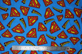 Flat swatch superman trademark fabric (bright blue fabric with tossed red and yellow superman logos, and "Superman" text in TM font and colours)