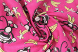 Swirled swatch monkey around fabric (bubblegum pink fabric with tossed yellow bananas and brown cartoon monkeys in various poses/faces)