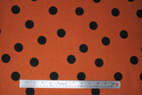 Flat swatch orange polka dots fabric (burnt orange fabric with medium/large black polka dots)