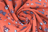 Swirled swatch robots printed fabric (orange fabric with tossed robot related full colour emblems: grey robots, red robots, wifi symbols, wrenches, cogs, etc.)