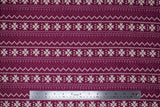 Flat swatch burgundy winter pattern fabric (Burgundy fabric with white Christmas sweater style pattern stripes with pixelated triangle design and quilt like floral repeated)