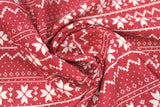 Swirled swatch red winter pattern fabric (red fabric with white Christmas sweater style pattern stripes with pixelated triangle design and quilt like floral repeated)