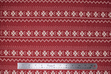 Flat swatch red winter pattern fabric (red fabric with white Christmas sweater style pattern stripes with pixelated triangle design and quilt like floral repeated)