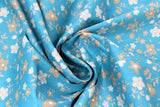 Swirled swatch Blue Floral Toss fabric (medium blue fabric with small tossed cream and tan floral heads and stems allover)