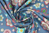Swirled swatch Blue Tossed Floral Heads fabric (blue denim look fabric with assorted sized tossed floral heads in white, pink, blue, green, teal, etc. in fun designs)