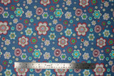 Flat swatch Blue Tossed Floral Heads fabric (blue denim look fabric with assorted sized tossed floral heads in white, pink, blue, green, teal, etc. in fun designs)