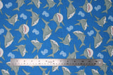 Flat swatch sharks fabric (medium blue fabric with tossed grey cartoon sharks allover in various sizes and poses, with tossed blue bubble clusters)