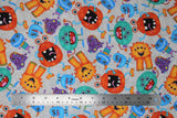 Flat swatch monsters fabric (light grey fabric with grey swirls and tossed large happy monsters allover in various shapes and orange, blue, teal, purple colours)