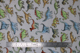 Flat swatch dinosaurs fabric (white fabric with tossed dinosaur illistrations in blue, green, tan shades)