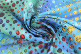 Swirled swatch blue glow fabric (blue and turquoise marbled look fabric with coloured paint drip look dots allover with black outlines green, yellow, red, blue black colourway)