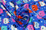 Swirled swatch Pawtraits fabric (royal blue fabric with scattered doodle style cat heads in white, black, red, pink and red with tossed squares, circles and triangles in various colours)