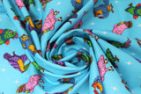 Swirled swatch Sky Birds fabric (blue fabric with tossed illustrative style birds allover in blues, greens, purples and yellow shades with tossed white star sparkles)
