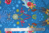 Flat swatch medium blue fabric with shadow floral and colourful flowers and giraffes, butterflies, high heeled shoes, printed fabric