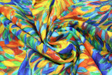 Swirled swatch peacock party fabric (small blue peacock bodies tossed with large floral finger paint style rainbow tail feathers allover, collage style fabric)