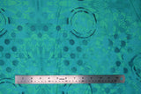 Flat swatch aqua medallion fabric (aqua coloured fabric with teal floral appliques and dark teal polka dots and black circular paint look marks)