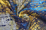 Swirled swatch Gilded Mosaic fabric (deep medium blue, yellow gold and white marbled look fabric with broken mosaic tiles look allover and subtle black text)