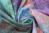 Swirled swatch Rue Le Peiter fabric (teal, blue, pink, purple marbled look fabric with subtle black lines, cursive text/numbers and subtle black floral/leaf design)