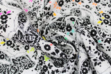 Swirled swatch linework themed fabric in lil' stinker (white fabric with floral skunks and multi coloured leaves)