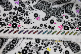 Raw hem swatch linework themed fabric in lil' stinker (white fabric with floral skunks and multi coloured leaves)