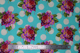 Flat swatch painted roses wonder fabric (teal blue fabric with white polka dots, tossed pink/orange roses with green leaves dripping with paint look in purple and pink with subtle dark purple polka dots)