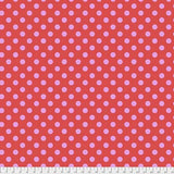 Swatch of pom pom (dots) printed fabric in poppy (pink/red)
