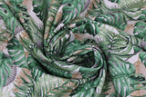 Swirled swatch leaves fabric (white fabric with tossed/collaged large green jungle-style leaves with beige and black leaf outlines in background)