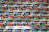Flat swatch Santorin fabric (barn board style fabric arrange in a brick like pattern in grey, brown, orange, purple, green, blue)