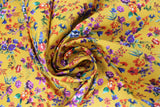 Swirled swatch of floral printed fabric in yellow