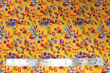 Flat swatch of floral printed fabric in yellow