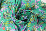 Swirled swatch of cactus printed fabric on teal