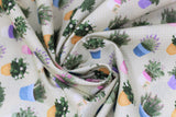 Swirled swatch Garden fabric (pale green fabric with tiny white polka dots and assorted potted plants allover. Green, yellow, purple, blue, pink pots with green plants and floral)