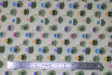 Flat swatch Garden fabric (pale green fabric with tiny white polka dots and assorted potted plants allover. Green, yellow, purple, blue, pink pots with green plants and floral)