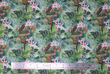 Flat swatch Jaya fabric (layered collage of jungle greenery leaves in various shades of green, with some pink/red turning leaves and white and red floral)