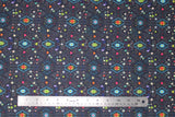 Flat swatch Carcas fabric (dark blue/black fabric with busy southwest look pattern with geometric style shapes allover in blue, orange, pink, purple colourway)
