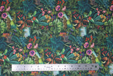 Flat swatch Venezuela fabric (dark green fabric with busy tropical look greenery and plants layered allover with pink and purple floral, tigers and zebras and small water scenes)