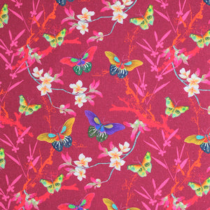 Square swatch Masako fabric (dark pink fabric with busy background including red and orange fibrous splatter shapes, grey branches with white flowers and pink leaves and butterflies tossed allover in multi-coloured shades)