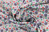Swirled swatch small floral fabric (bright aqua fabric with small collaged floral heads allover in purple, red, pink)
