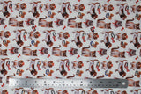 Flat swatch bows fabric (white fabric with tossed dogs and cats in brown, white and grey with red and bronze bows and collars tossed)