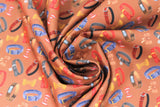 Swirled swatch collars fabric (brown fabric with red, bronze, yellow bows and grey, brown, blue, red collars tossed allover)