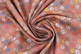 Swirled swatch paw prints fabric (brown fabric with tossed small paw prints in white, grey, brown, blue, orange, pink, red, yellow)