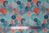 Flat swatch coral fabric (off white fabric with tossed coral plant drawings/silhouettes in teal, light and dark blue, orange, with tossed blue and orange fish and sea plants/shells)
