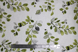 Flat swatch of decor weight canvas in green leaves on white
