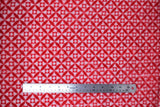 Flat swatch (side 1) Grizzly fabric (white and red decorative geometric circles allover)