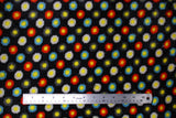 Flat swatch (side 2) Camion fabric (black fabric with yellow dots allover outlined in thick blue, red, black or white organic circle shapes)