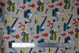 Flat swatch (side 1) Camion fabric (grey fabric with scattered cartoon construction equipment in various styles in red, blue white and yellow colours)