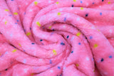 Swirled swatch (side 2) Arielle fabric (coral pink fabric with scattered dots in white, black, blue and yellow)