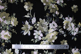 Flat swatch Floral fabric (black fabric with large tossed floral heads and stems/greenery in white, grey, pale greens and blue shades)