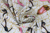 Swirled swatch glam themed fabric in glam heels (white fabric with faint gold geometric pattern and tossed high heels allover in black, pink, and gold)
